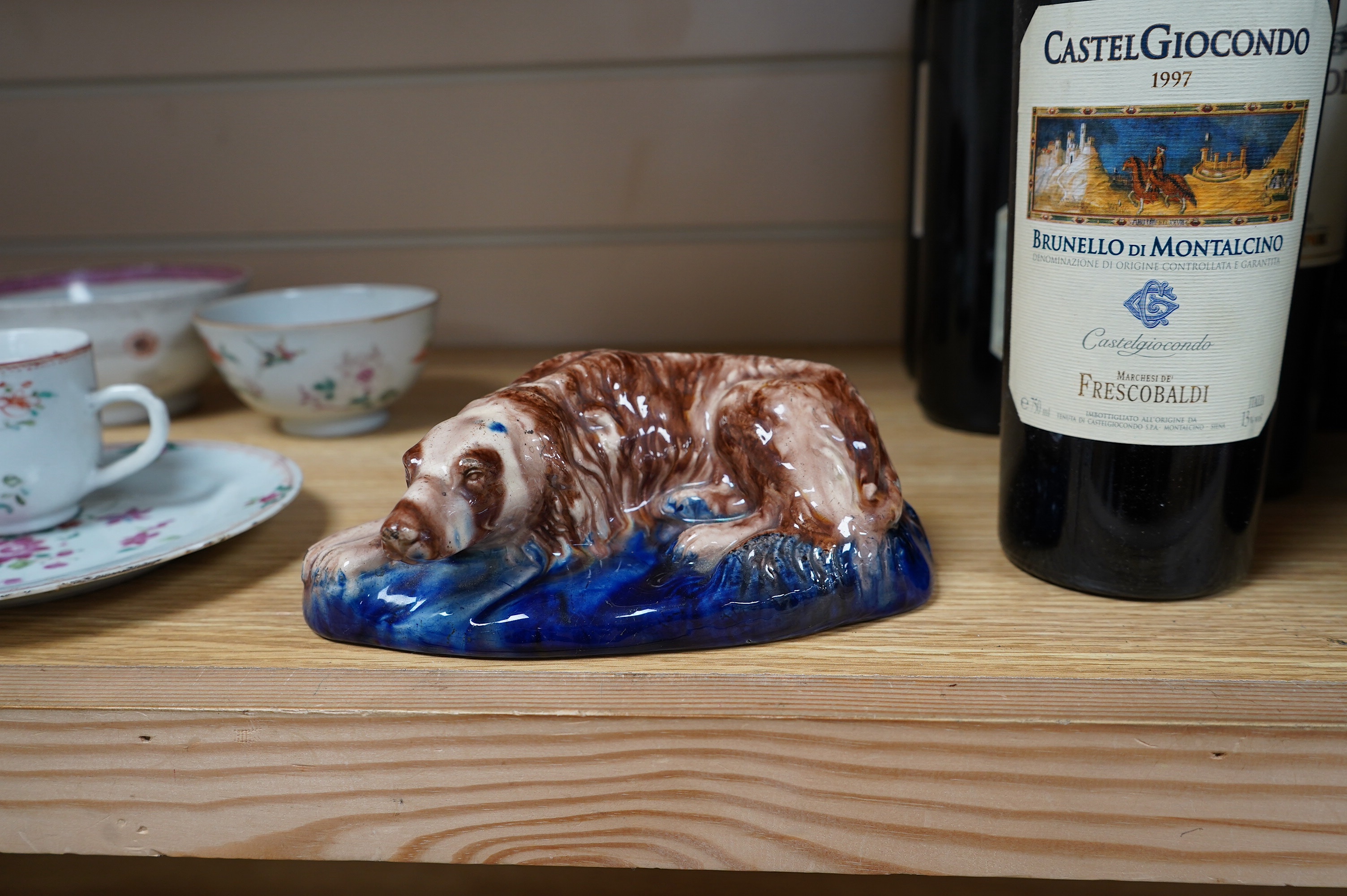 A late 19th century earthenware model of a recumbent hound, possibly Scottish, Portobello, 18.5cm wide. Condition - fair to good